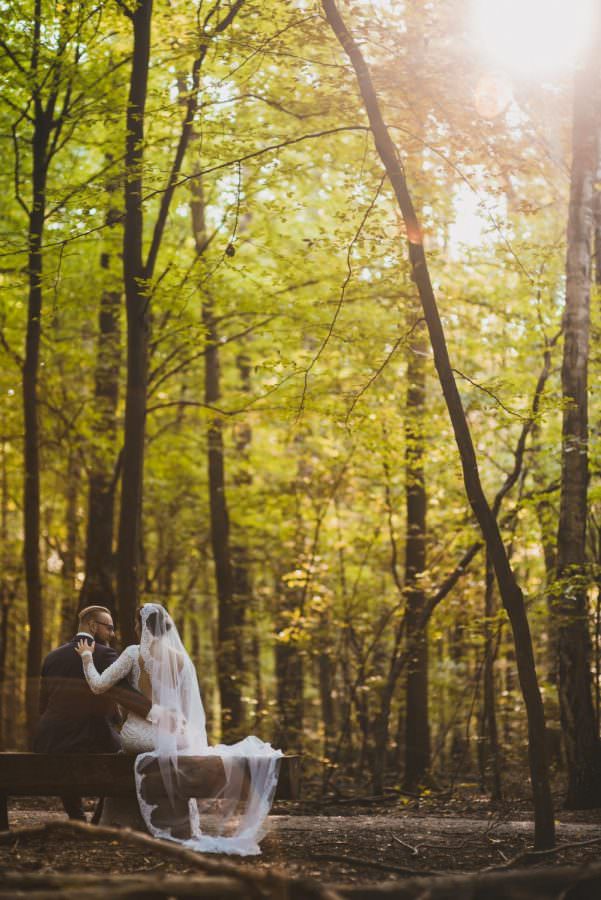 groom and bride on bench
