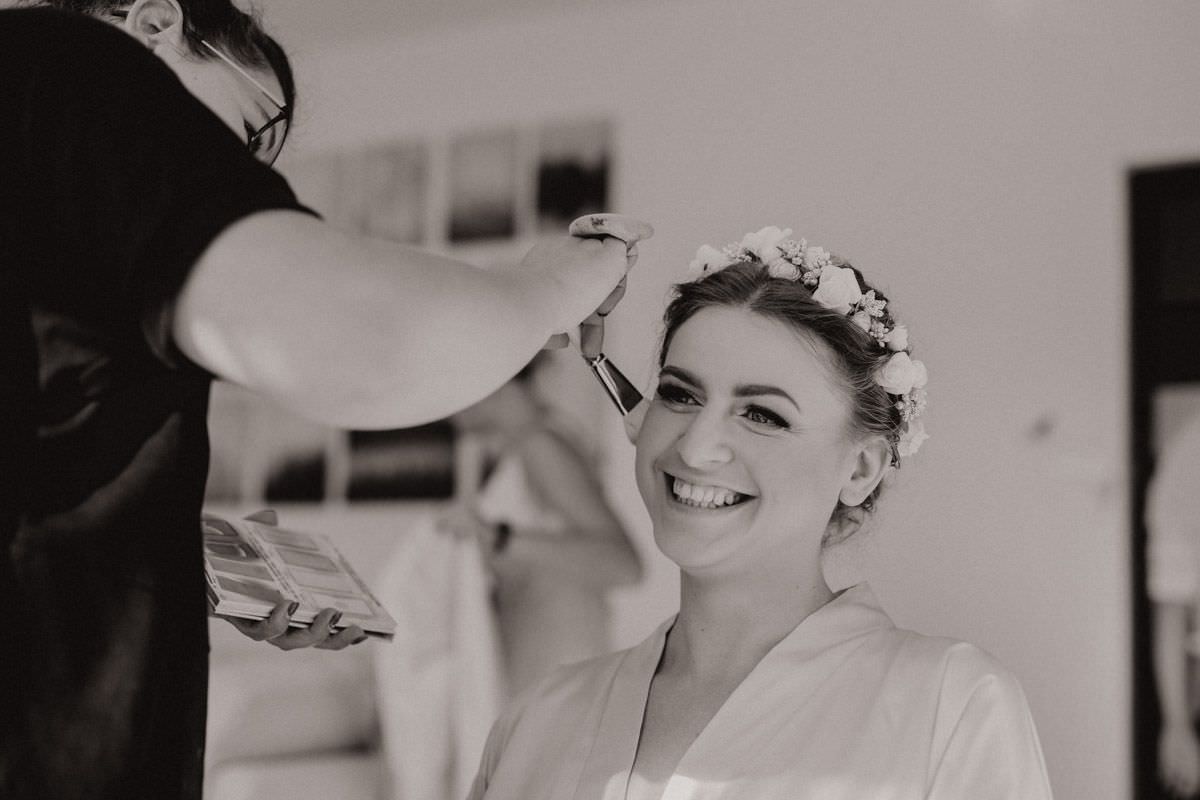 make-up artist doing wedding makeup to the bride