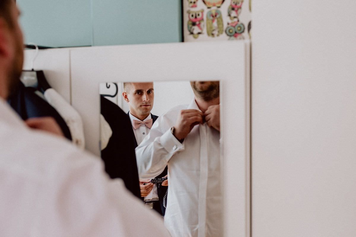 groomsman prepares the groom for the wedding